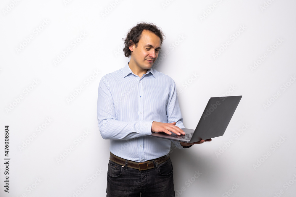 Business man with a laptop over a white background