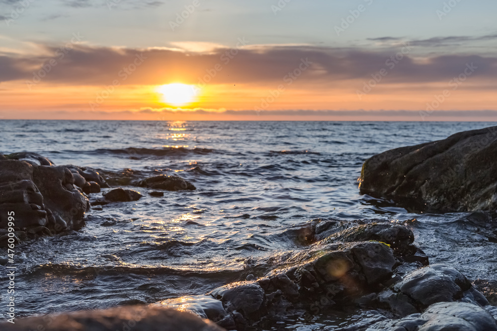 The seashore at the dawn of a bright orange sky during the sunrise of the sun. The seashore at the dawn of a bright orange sky during the sunrise of the sun.