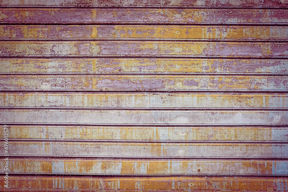 Purple, violet, orange and blue old wooden texture background. Multicolor backdrop. Scratched weathered wooden wall with peeled off colorful paint close up. Horizontal wooden boards. Copy space