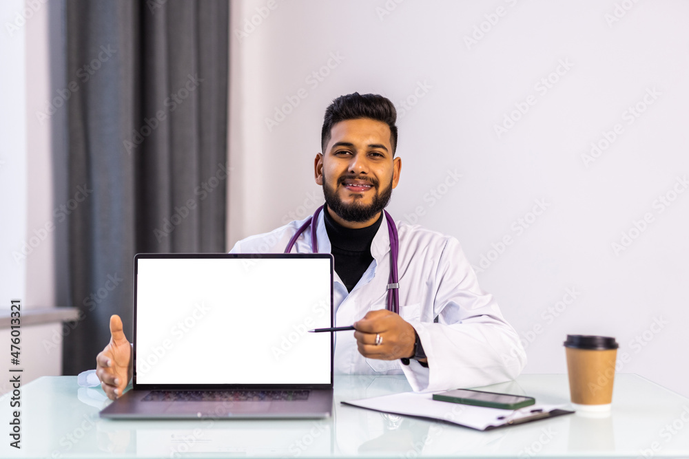 Male doctor using laptop computer with white mockup screen technology tele medicine healthcare e website ad, watching e learning medical online telehealth webinar, writing report. Male doctor using laptop computer with white mockup screen technology tele medicine healthcare e website ad, watching e learning medical online telehealth webinar, writing report.