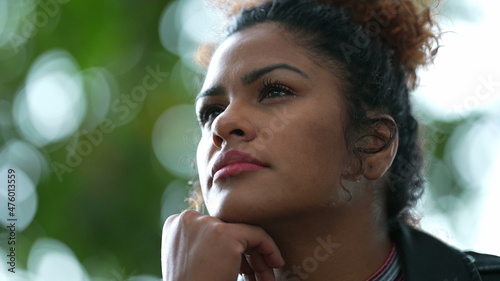 Pensive woman thinking outside. Brazilian person in contemplation lost in thought