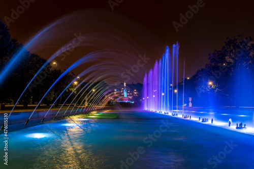 Fountain with water jets illuminated at night in the fountain of the Jose Antonio Labordeta public park in the city of Zaragoza, Spain. Long exposure image photo