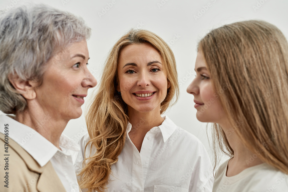 Adult woman between her daughter and mother Adult woman between her daughter and mother