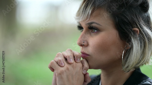 Contemplative woman praying to God. Person prays to divinity with HOPE and FAITH