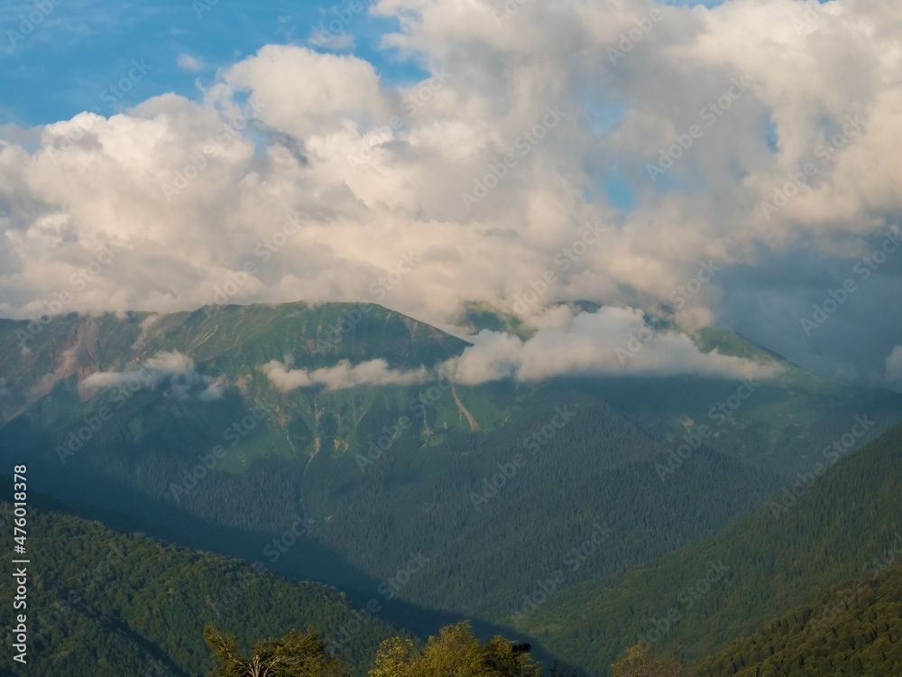 Beautiful green mountains and clouds in the resort of Rosa Khutor
