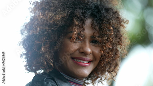 Brazilian black woman portrait close-up face looking at camera with curly hair