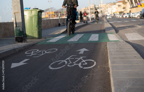 Wallpaper Mural Bicycle lane dedicated of separate for move cyclists on road in city. Arrows show movement in one and other directions. Sign on road ensures safety of people's lives Person rides on bike.   Torontodigital.ca