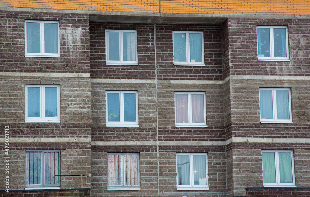 Fototapeta premium new multi-storey houses built of brick, and multiple windows