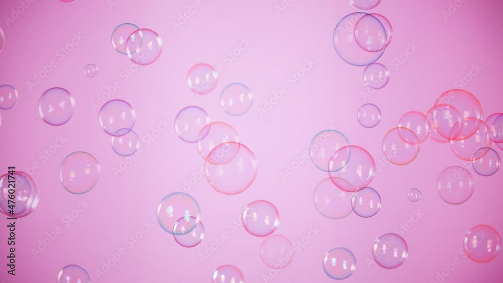 Super Slow Motion Shot of Flying Colorful Soap Bubbles on Pink Background at 1000 fps.