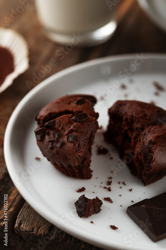 Food photo. Chocolate muffins and a glass of milk on a wooden background