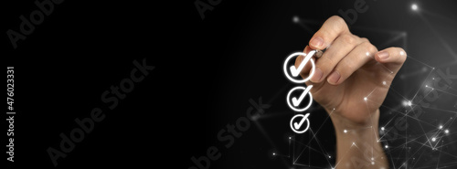 Hand marking checklist, to do list concept. Planning business at home, hand with pen on a black background, banner photo