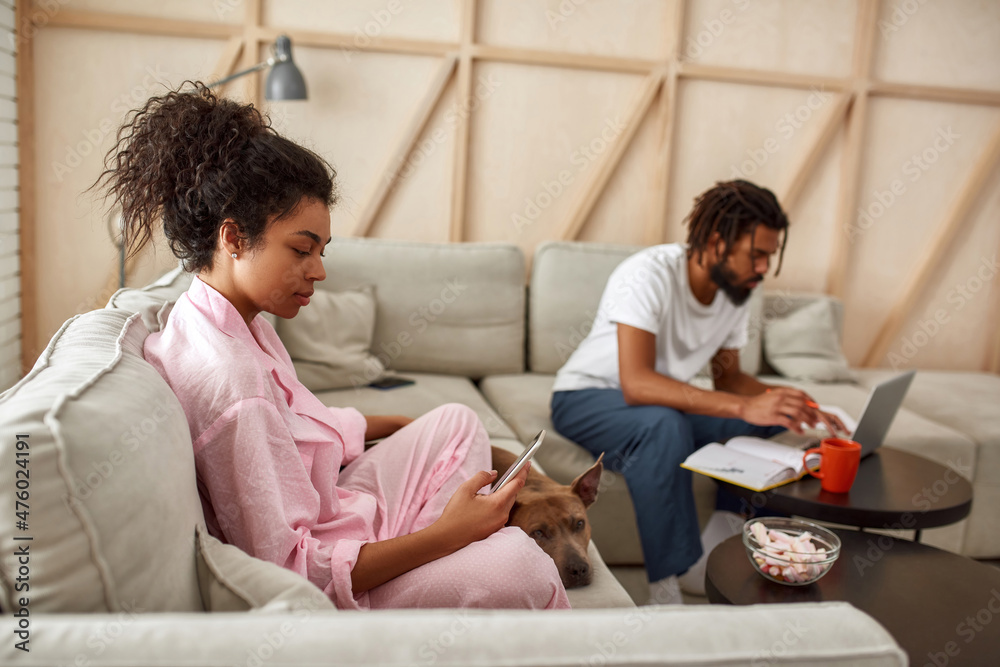 Man work with laptop and woman with phone and dog Man work with laptop and woman with phone and dog