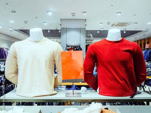 Two male mannequin torsos in pullovers on the background of the store photo