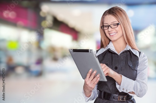 Clothing Store, Female Visual Merchandising Professional Uses Tablet Computer