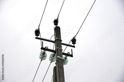 Transmission towers and power lines against a gloomy sky.