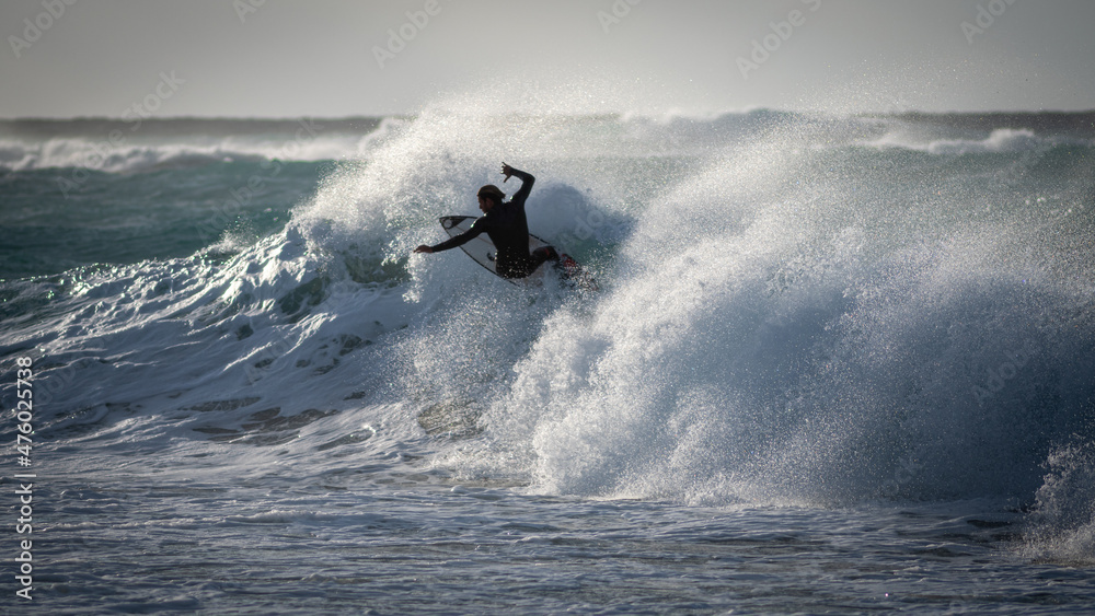 Isolated close up of a single brave surfer riding the stormy waves- Israel Isolated close up of a single brave surfer riding the stormy waves- Israel