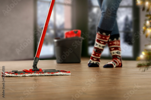 Cleaning, washing the floor free space in Christmas time and blurry background 