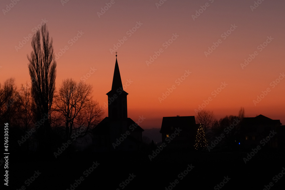 Sunset silhouette of the idyllic village of Busskirch  on the shores of the Upper Zurich Lake (Obersee), Rapperswil-Jona, St. Gallen, Switzerland