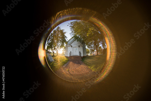 Beautiful view from the peephole to the house with large trees photo