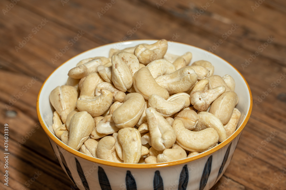 Dried cashew nuts in containers on wooden countertops Dried cashew nuts in containers on wooden countertops