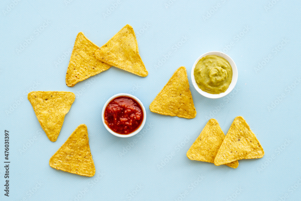 Mexican snacks nachos with salsa and guacamole sause. Fast food background Mexican snacks nachos with salsa and guacamole sause. Fast food background