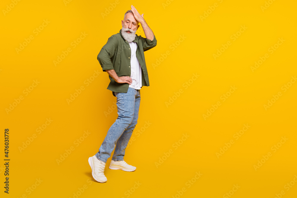 Full length body size photo of senior man in stylish clothes dancing at party isolated vivid yellow color background with copyspace Full length body size photo of senior man in stylish clothes dancing at party isolated vivid yellow color background with copyspace