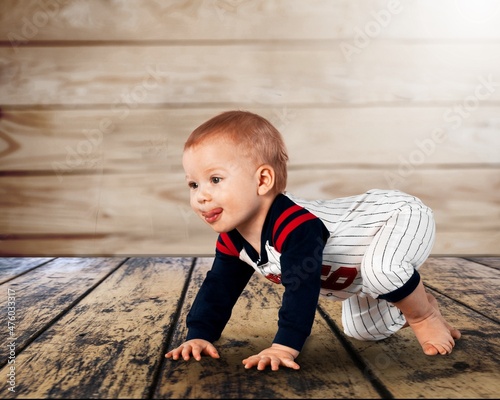 Lying on floor. Little smiling cute child. Concept of emotions, facial expressions.