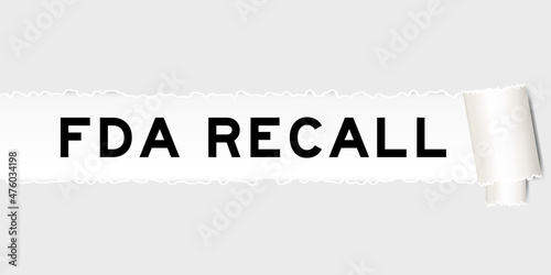 Ripped gray paper background that have word FDA recall under torn part