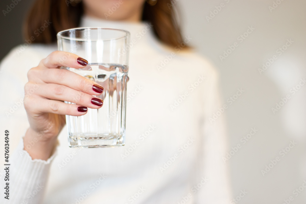 water glass standing in woman's hand water glass standing in woman's hand