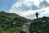 A man enjoying the panoramic view on the snow-capped peaks of Tetnuldi, Gistola and Lakutsia in the Greater Caucasus Mountain Range in Georgia, Svaneti Region. Wanderlust, solitude, hiking trail.