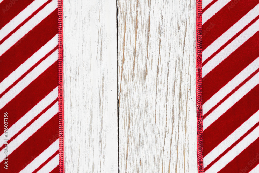 Red and white candy cane striped border Christmas background with weathered wood Red and white candy cane striped border Christmas background with weathered wood