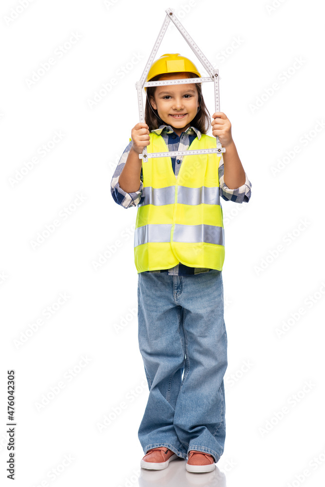 building, construction and profession concept - smiling little girl in protective helmet and safety vest with ruler in shape of house over white background building, construction and profession concept - smiling little girl in protective helmet and safety vest with ruler in shape of house over white background