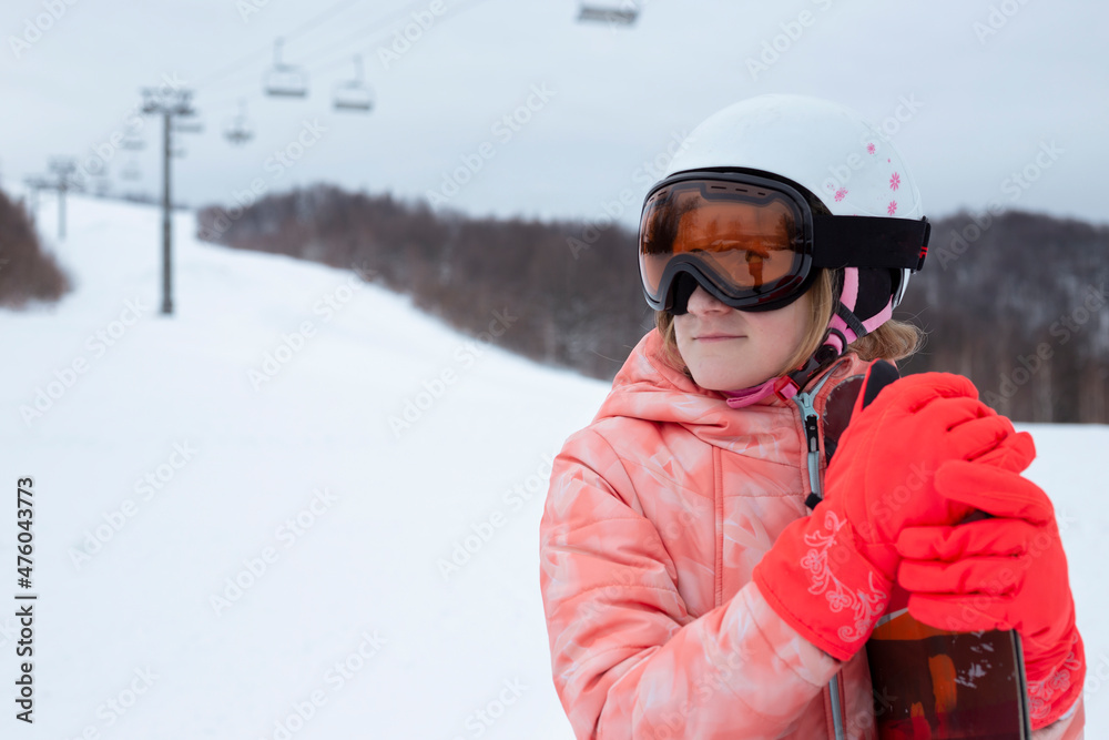 happy girl in ski resort riding snowboard