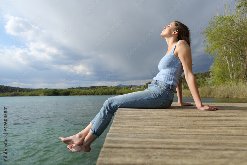 Woman relaxing sitting in a pier