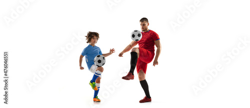 Sport collage. Man, professional soccer player and little boy training together isolated over white studio background