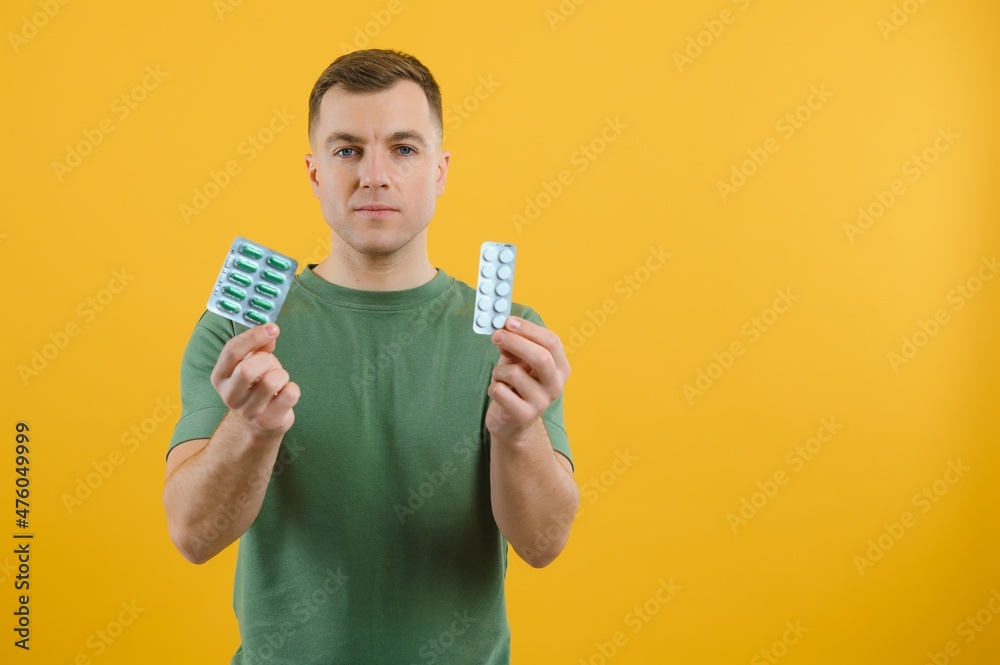 Vitamin complex. Handsome man take medication. Health care. More commonly prescribed antidepressants. Investment in health. Medicines concept. Food additives vitamins for male health Vitamin complex. Handsome man take medication. Health care. More commonly prescribed antidepressants. Investment in health. Medicines concept. Food additives vitamins for male health