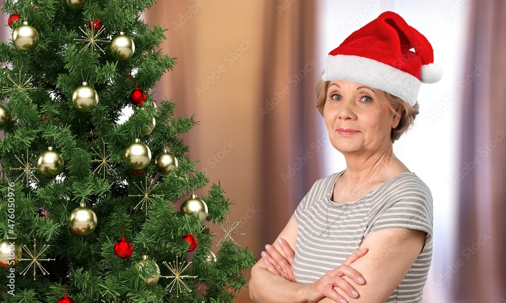 Elderly Caucasian woman Santa hat. Christmas eve, gift, Christmas tree. Elderly Caucasian woman Santa hat. Christmas eve, gift, Christmas tree.