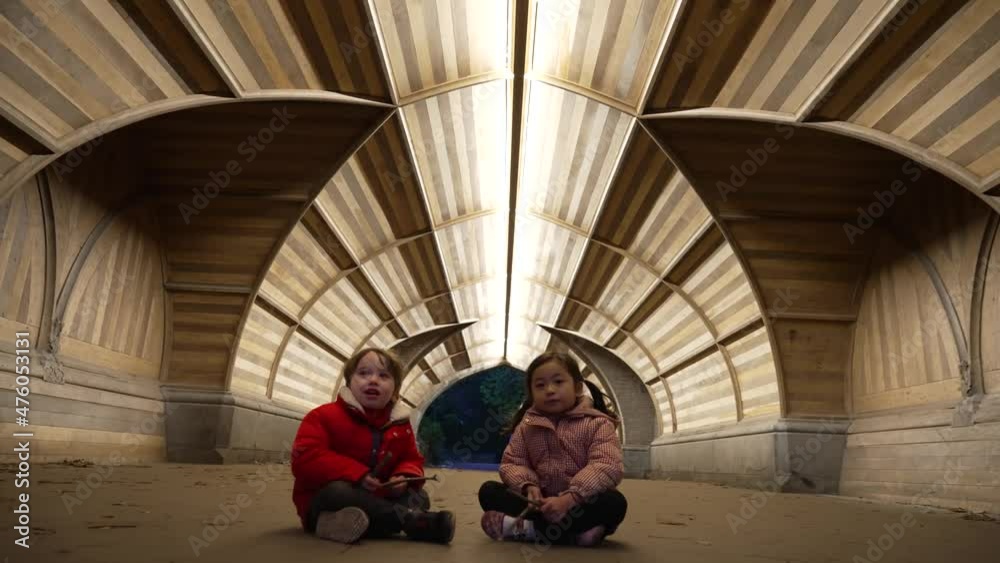 Close up view of a girl and boy while sitting on ground on a wintry Eve.True friendship, friends for ages. Close up view of a girl and boy while sitting on ground on a wintry Eve.True friendship, friends for ages.