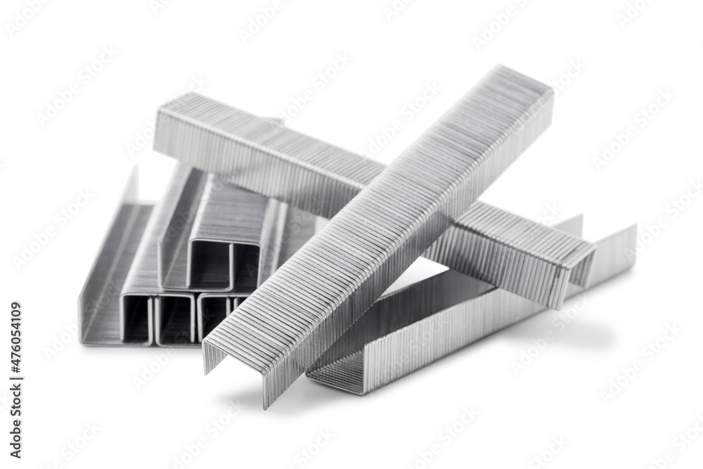 Stack of metal staples for stapler gun isolated on white background, close up. Industrial tool. - obrazy, fototapety, plakaty 