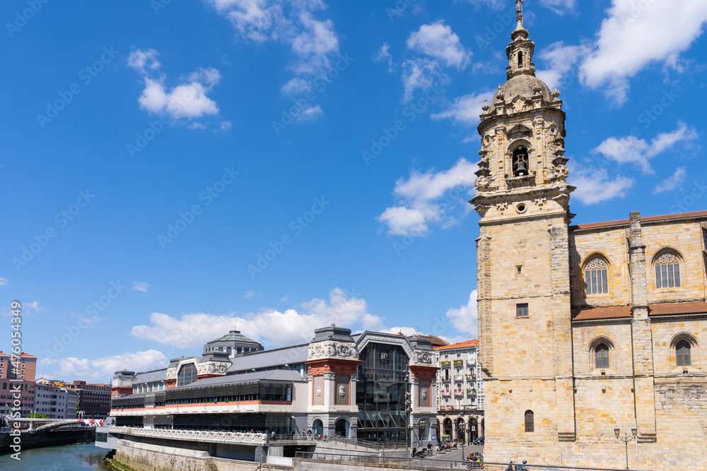 Famous Ribera Market by Nervion river and San Anton Church in Bilbao old town city on sunny day. Iconic landmark of Vizcaya capital