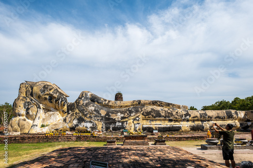 Reclining Buddha statue in Wat Lokaya Sutharam temple in Ayutthaya, a popular travel destination for tourists in Thailand. The famous huge reclining Buddaha in Ayutthaya city. photo