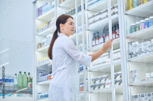 Pharmacist checking medicines in a drugstore photo