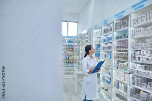 Pharmacist checking medicines in a drugstore