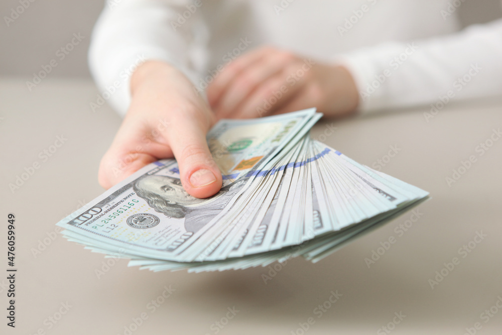 Many dollar bills in female hands close up Many dollar bills in female hands close up