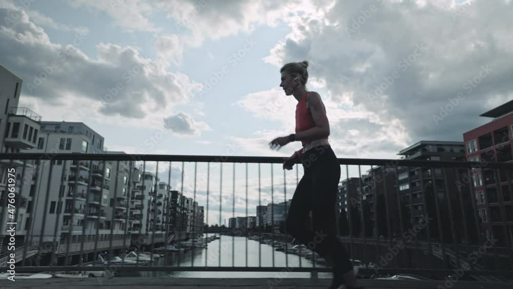 Senior woman running on street with smart watch on wrist Senior woman running on street with smart watch on wrist