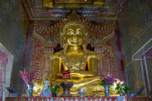 Mandalay, Myanmar, November 2017 - view of a golden budhha statue in a shrine at Mandalay Hill photo