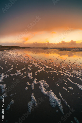 Vertical shot of the sunset above the sea. Veersedam, Zeeland, the Netherlands. photo