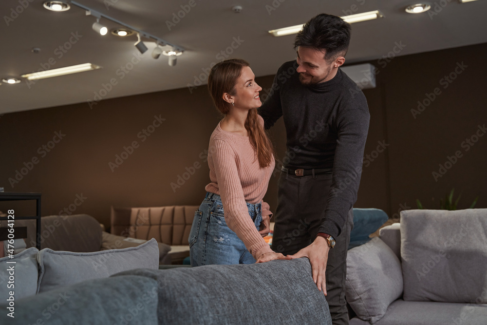 Joyous romantic couple shopping for new sofa Joyous romantic couple shopping for new sofa