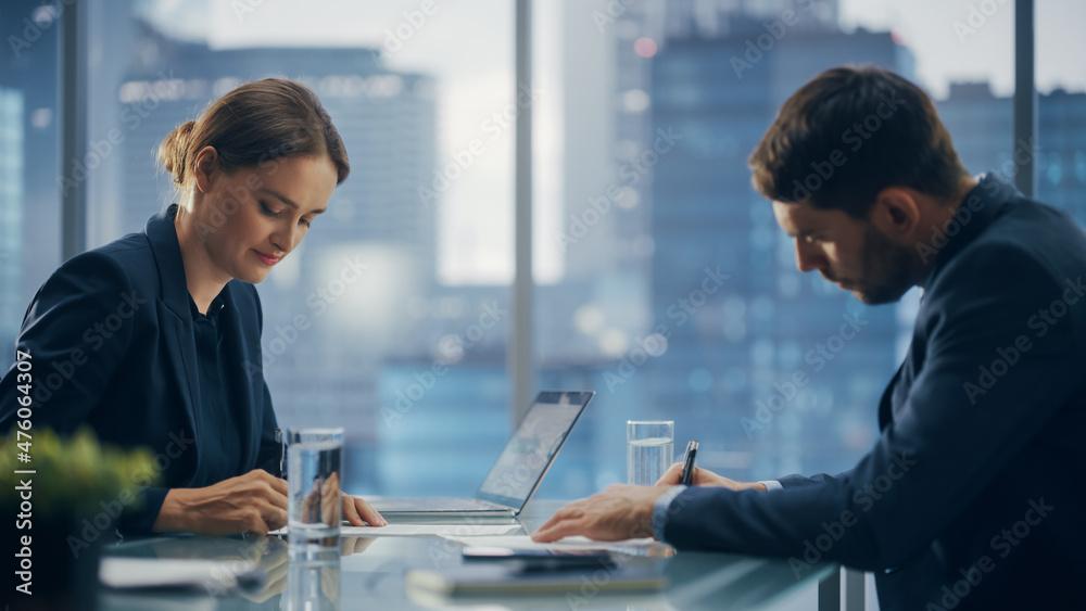 Female and Male Business Partners Sign Deal Documents in Meeting Room Office. Corporate CEO and Investment Manager Working Next to Window with Big City with Skyscrapers View Female and Male Business Partners Sign Deal Documents in Meeting Room Office. Corporate CEO and Investment Manager Working Next to Window with Big City with Skyscrapers View