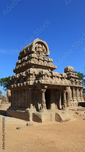 This is "five rathas" as they resemble the processional chariots of a temple. Statues carved in rock. this is one features in several Hindu scriptures. blue sky backgrounds © Udayakumar